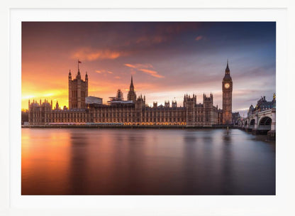 A framed photograph of the Houses of Parliament and Big Ben in London at sunset, with a dramatic orange and purple sky reflecting in the calm waters of the River Thames. Artwork