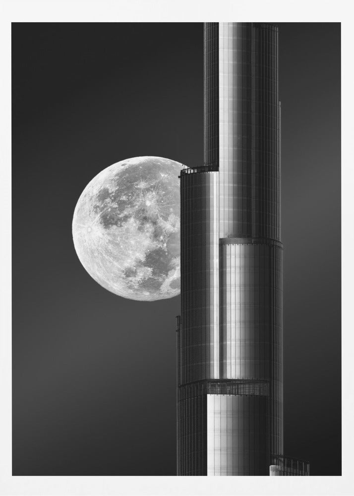 A dramatic black and white photograph of a massive full moon positioned next to a modern, towering skyscraper. The high-contrast image creates a striking juxtaposition between the natural celestial body and the man-made architectural marvel against a dark night sky. Poster