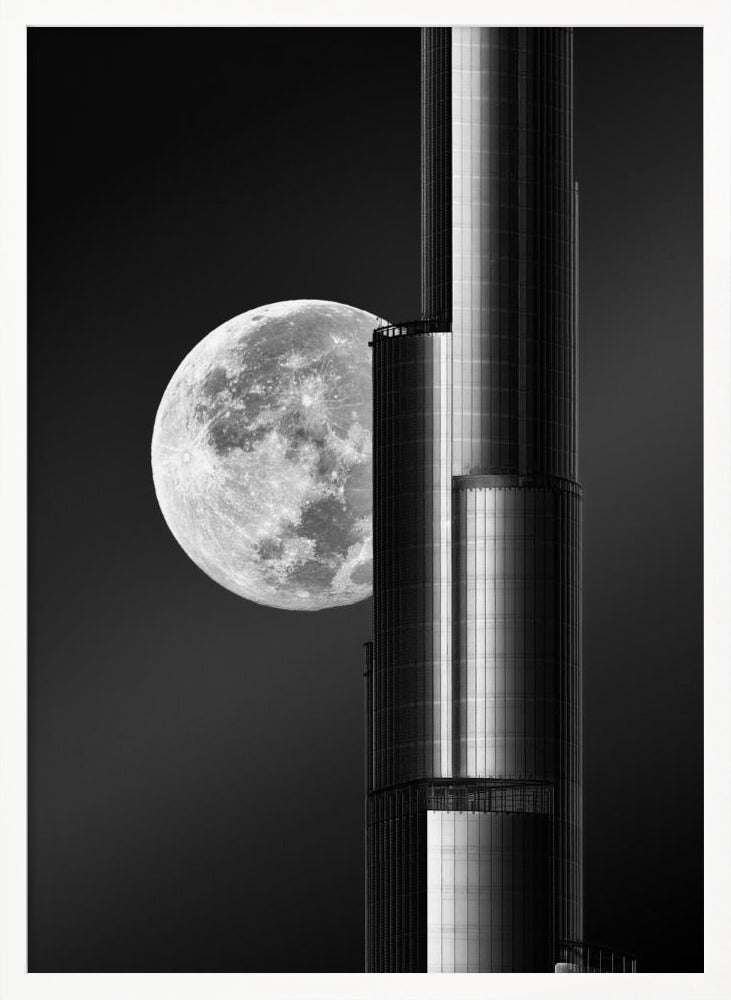 A dramatic black and white photograph of a massive full moon positioned next to a modern, towering skyscraper. The high-contrast image creates a striking juxtaposition between the natural celestial body and the man-made architectural marvel against a dark night sky. Poster