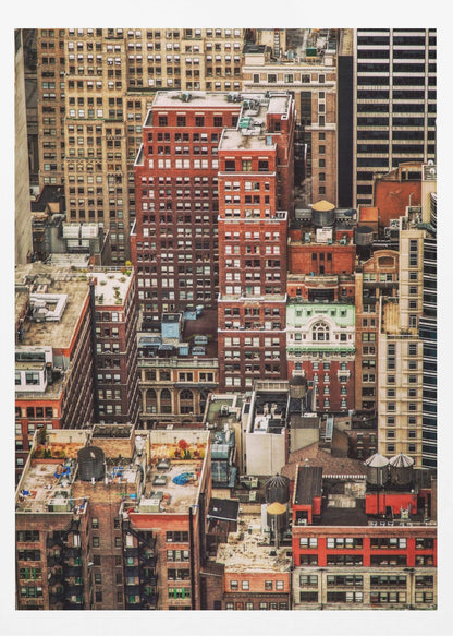 A high-angle, telephoto view of a dense cluster of New York City buildings, featuring a mix of red and brown brick architecture, with numerous windows creating a geometric pattern and several classic wooden water towers perched on the rooftops. Print