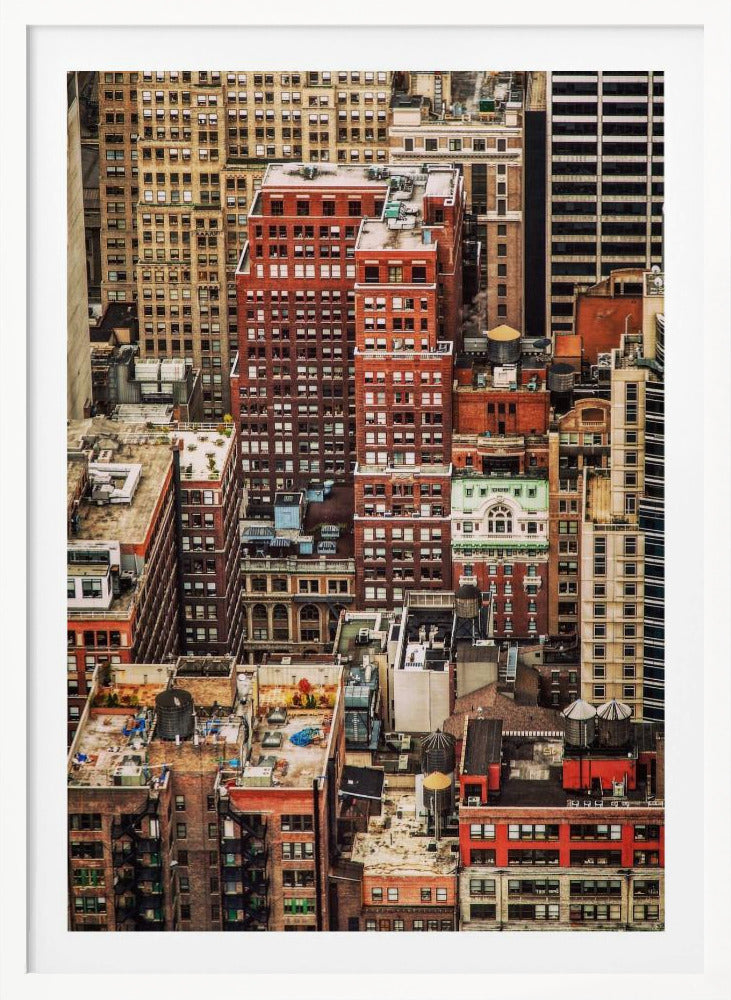 A high-angle, telephoto view of a dense cluster of New York City buildings, featuring a mix of red and brown brick architecture, with numerous windows creating a geometric pattern and several classic wooden water towers perched on the rooftops. Print