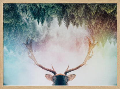 A surreal double-exposure artwork featuring the back of a deer's head with large antlers, blended with an image of a misty pine forest. The forest is reflected above the antlers against a soft, pastel-colored background, all enclosed in a silver frame. Print