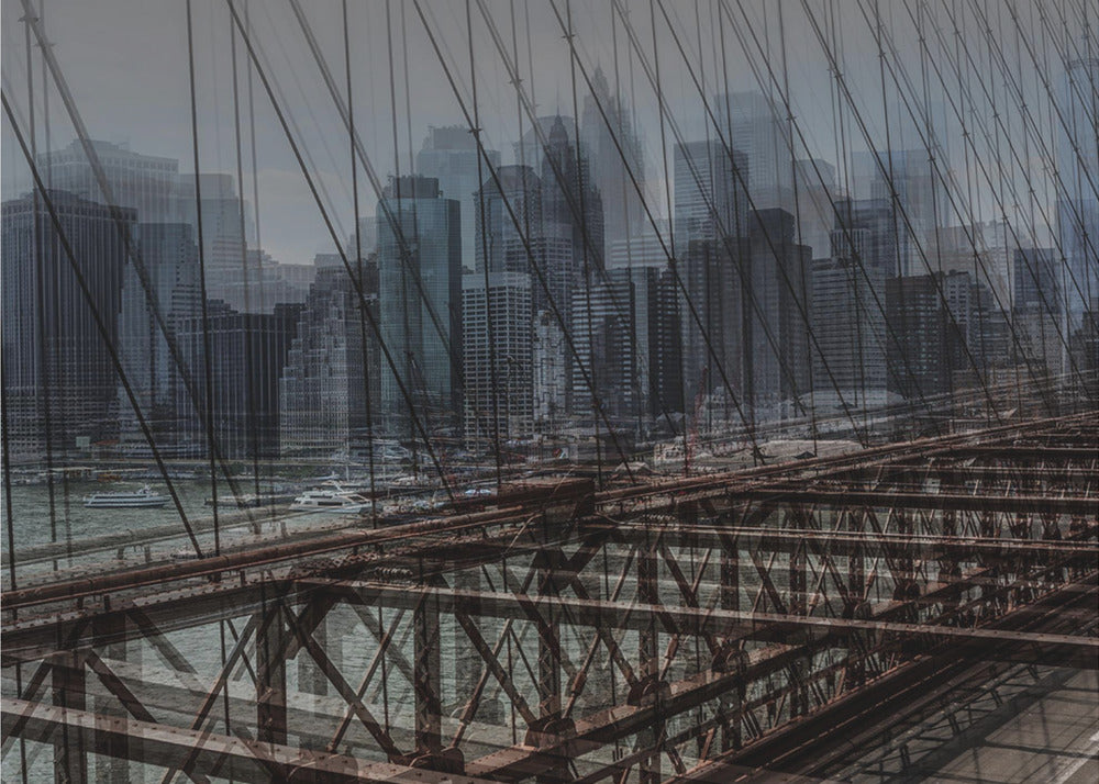 A framed, stylized photograph showing a double exposure of the New York City skyline and the intricate steel structure and cables of the Brooklyn Bridge, creating a dense, layered urban scene with a cool, moody color palette. Decor