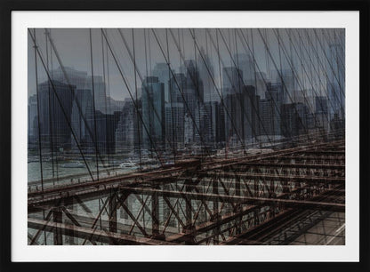 A framed, stylized photograph showing a double exposure of the New York City skyline and the intricate steel structure and cables of the Brooklyn Bridge, creating a dense, layered urban scene with a cool, moody color palette. Decor