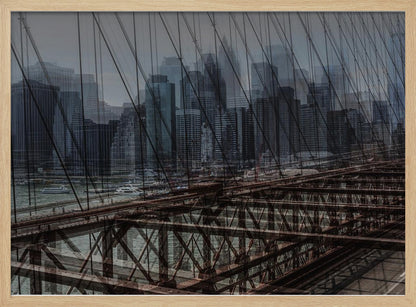 A framed, stylized photograph showing a double exposure of the New York City skyline and the intricate steel structure and cables of the Brooklyn Bridge, creating a dense, layered urban scene with a cool, moody color palette. Decor