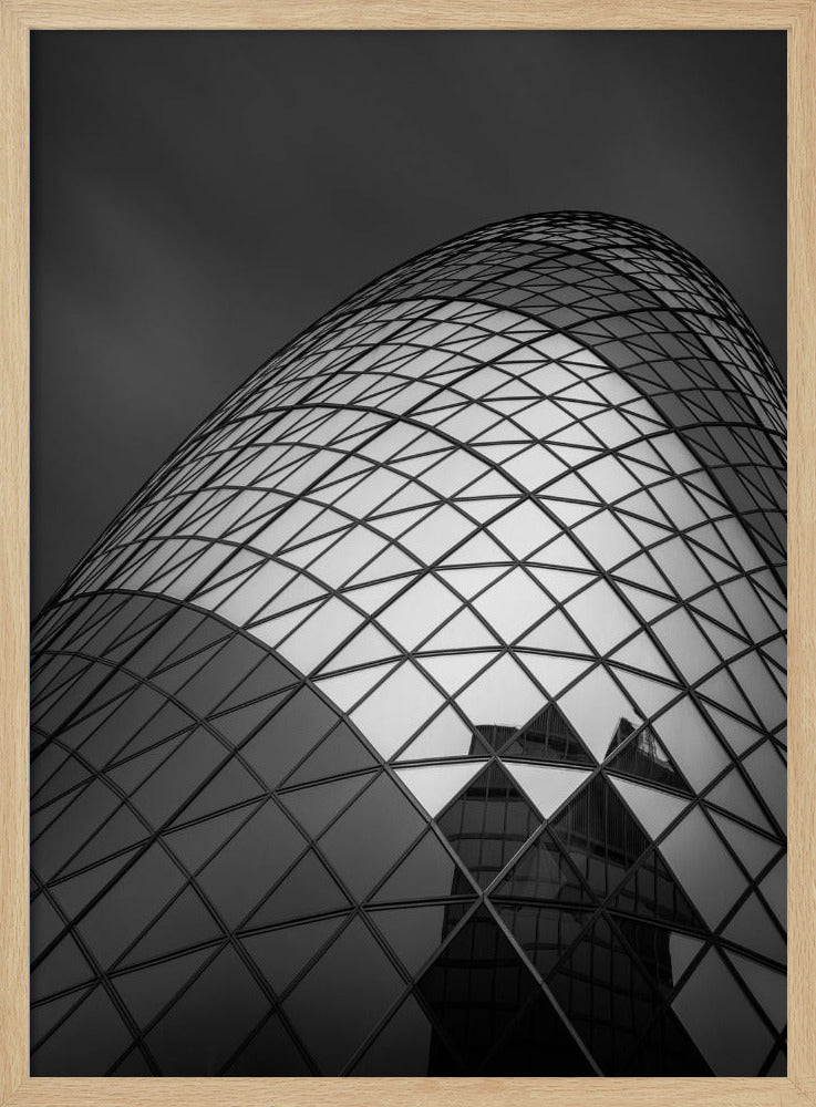 A framed, low-angle, black and white photograph of the curved, glass-paneled facade of a modern skyscraper, creating a dynamic pattern of reflective diamonds against a dark, moody sky. Artwork