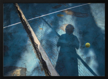 An artistic, high-angle shot of a weathered blue tennis court. The shadow of a tennis player holding a racket is cast across the court, with a yellow tennis ball suspended in mid-air nearby. A tattered tennis net runs diagonally across the frame, all enclosed within a silver border. Wall Art