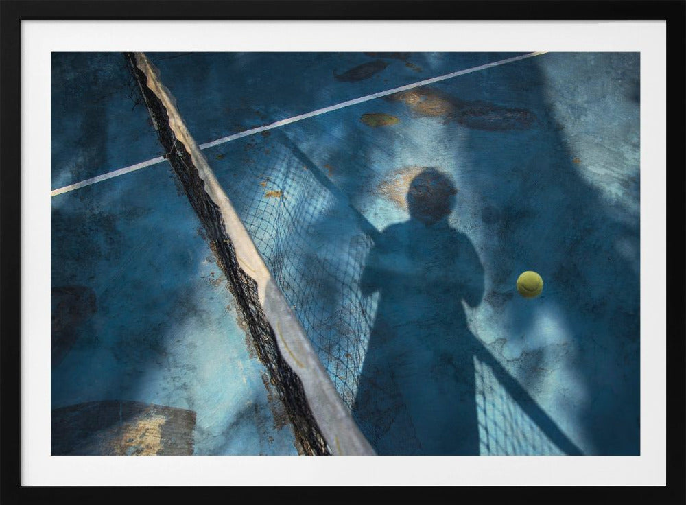 An artistic, high-angle shot of a weathered blue tennis court. The shadow of a tennis player holding a racket is cast across the court, with a yellow tennis ball suspended in mid-air nearby. A tattered tennis net runs diagonally across the frame, all enclosed within a silver border. Wall Art