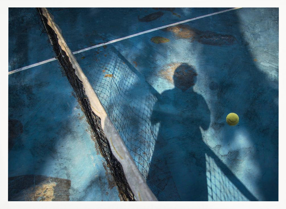 An artistic, high-angle shot of a weathered blue tennis court. The shadow of a tennis player holding a racket is cast across the court, with a yellow tennis ball suspended in mid-air nearby. A tattered tennis net runs diagonally across the frame, all enclosed within a silver border. Wall Art