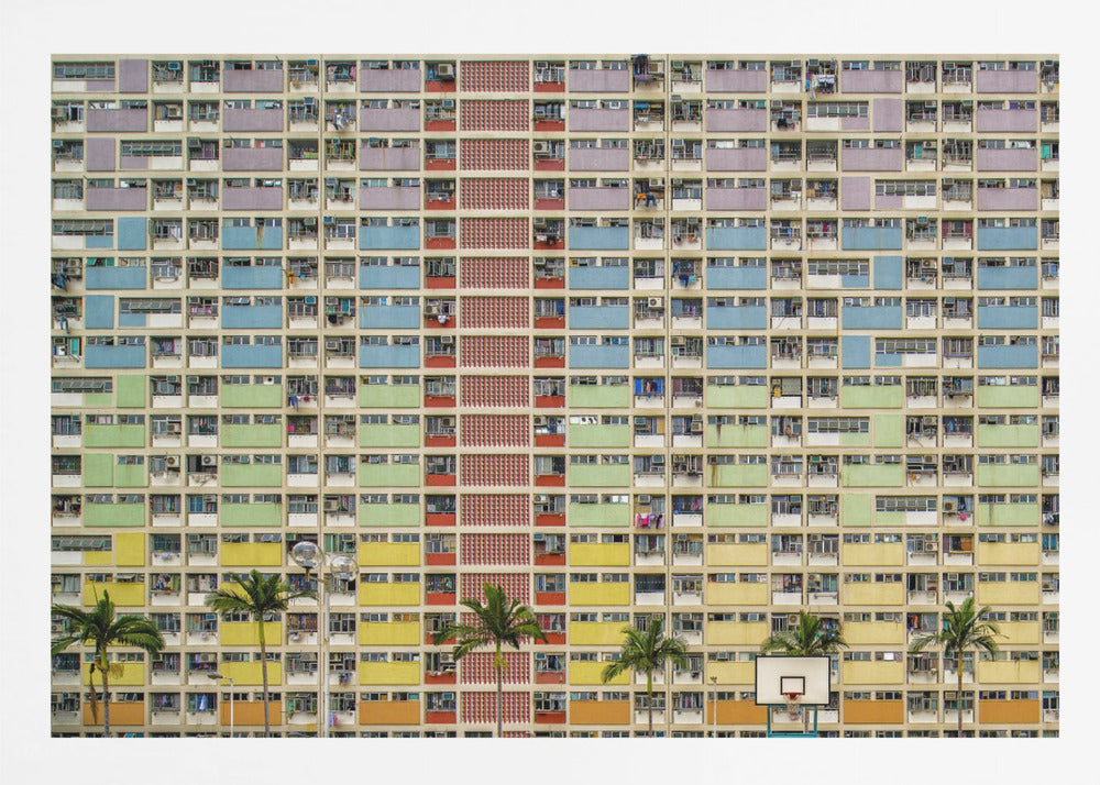 A symmetrical, frontal photograph of the colorful Choi Hung Estate in Hong Kong, featuring a massive grid of apartments with balconies painted in a rainbow of pastel colors including purple, blue, green, yellow, and orange. Palm trees and a basketball court are visible at the base of the building, which is enclosed in a silver frame. Wall Art