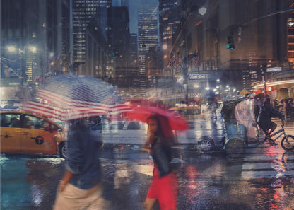 An artistic motion-blur photograph of a rainy night on East 42nd Street in New York City. Pedestrians with umbrellas, one with an American flag design and another bright red, cross the wet street as city lights and a yellow taxi reflect on the pavement, creating a vibrant, impressionistic scene within a silver frame. Decor