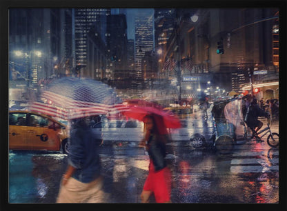 An artistic motion-blur photograph of a rainy night on East 42nd Street in New York City. Pedestrians with umbrellas, one with an American flag design and another bright red, cross the wet street as city lights and a yellow taxi reflect on the pavement, creating a vibrant, impressionistic scene within a silver frame. Decor