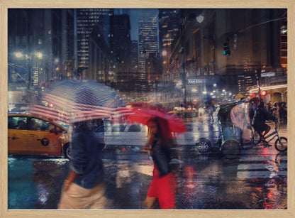 An artistic motion-blur photograph of a rainy night on East 42nd Street in New York City. Pedestrians with umbrellas, one with an American flag design and another bright red, cross the wet street as city lights and a yellow taxi reflect on the pavement, creating a vibrant, impressionistic scene within a silver frame. Decor