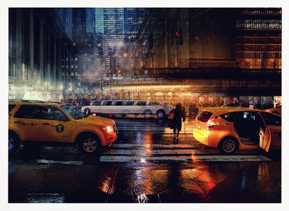 A cinematic night photograph of a busy, wet city street, likely New York, with yellow taxis in the foreground and a white stretch limousine in the background. A pedestrian crosses the street as the city lights reflect off the wet pavement, with illuminated skyscrapers towering above. Decor