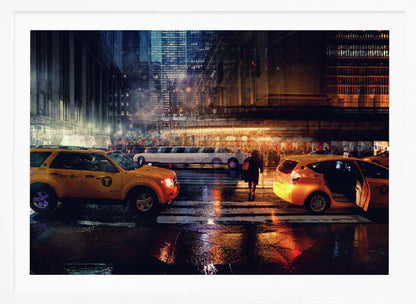 A cinematic night photograph of a busy, wet city street, likely New York, with yellow taxis in the foreground and a white stretch limousine in the background. A pedestrian crosses the street as the city lights reflect off the wet pavement, with illuminated skyscrapers towering above. Decor
