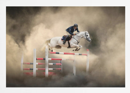 A dramatic action shot of a person in a blue jacket and helmet riding a powerful white horse as it leaps over a red and white striped obstacle, all enveloped in a swirling cloud of brown dust. Print