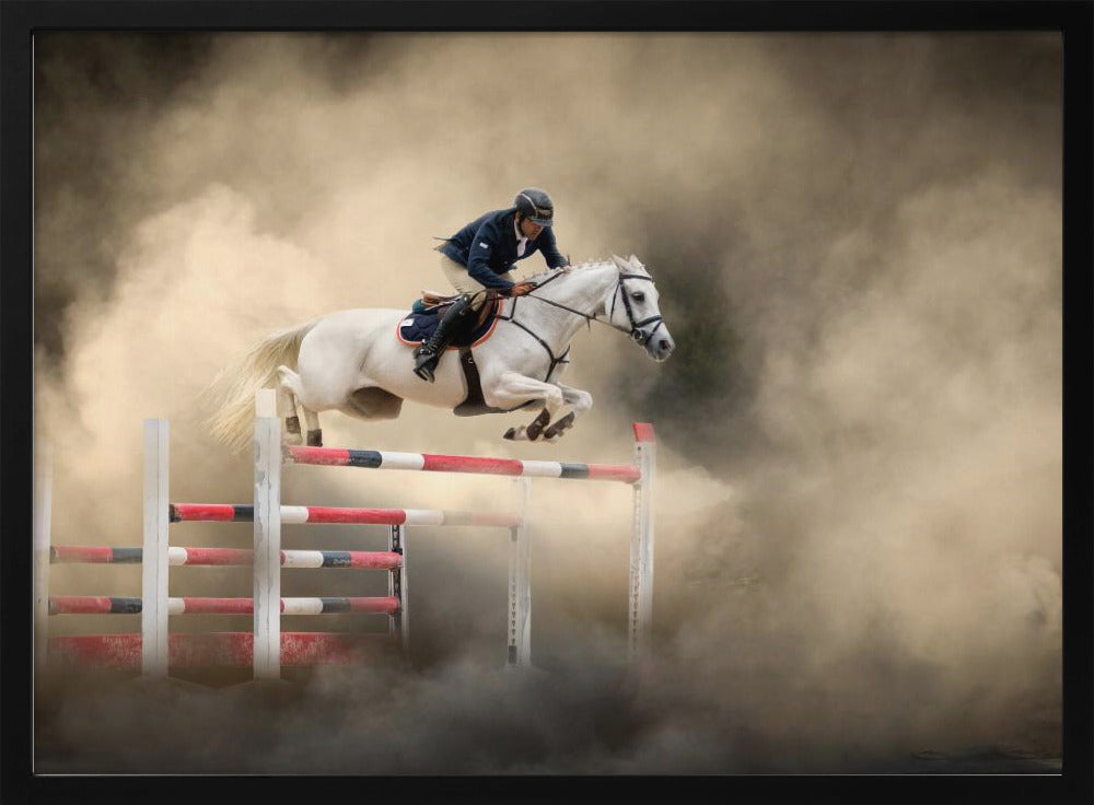 A dramatic action shot of a person in a blue jacket and helmet riding a powerful white horse as it leaps over a red and white striped obstacle, all enveloped in a swirling cloud of brown dust. Print