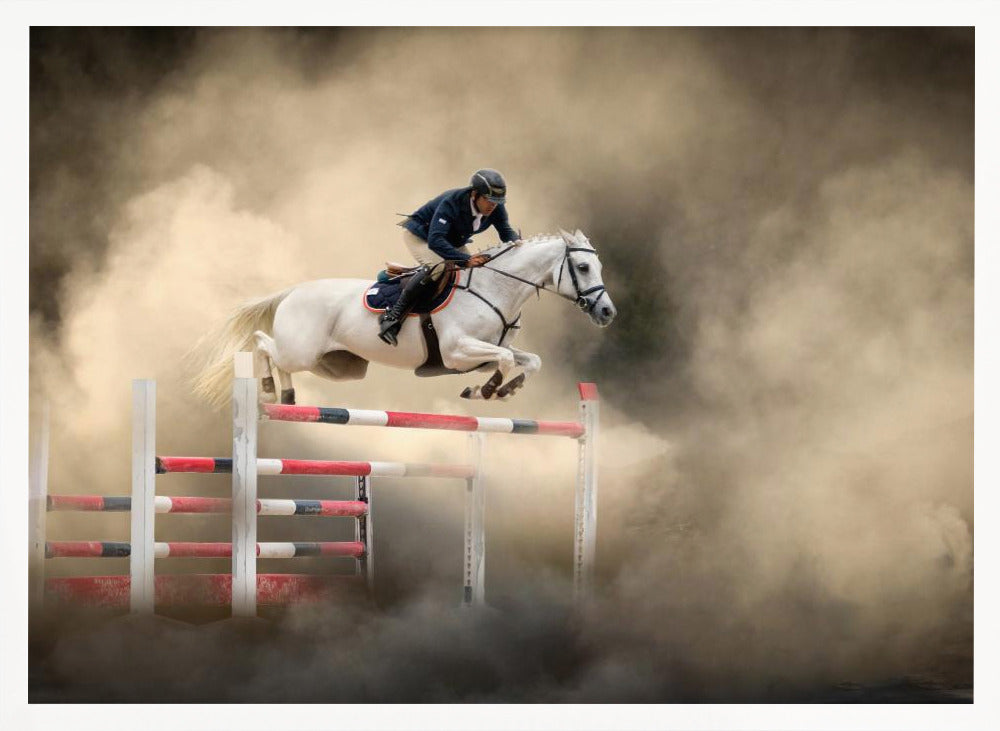 A dramatic action shot of a person in a blue jacket and helmet riding a powerful white horse as it leaps over a red and white striped obstacle, all enveloped in a swirling cloud of brown dust. Print
