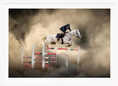 A dramatic action shot of a person in a blue jacket and helmet riding a powerful white horse as it leaps over a red and white striped obstacle, all enveloped in a swirling cloud of brown dust. Print