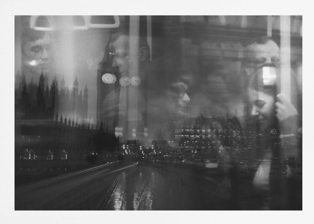 A moody black and white double exposure photograph showing a rainy London street at night with Big Ben, overlaid with the faint reflections of people inside a moving vehicle like a bus. The image has a dreamy, layered effect and is displayed in a silver frame. Print