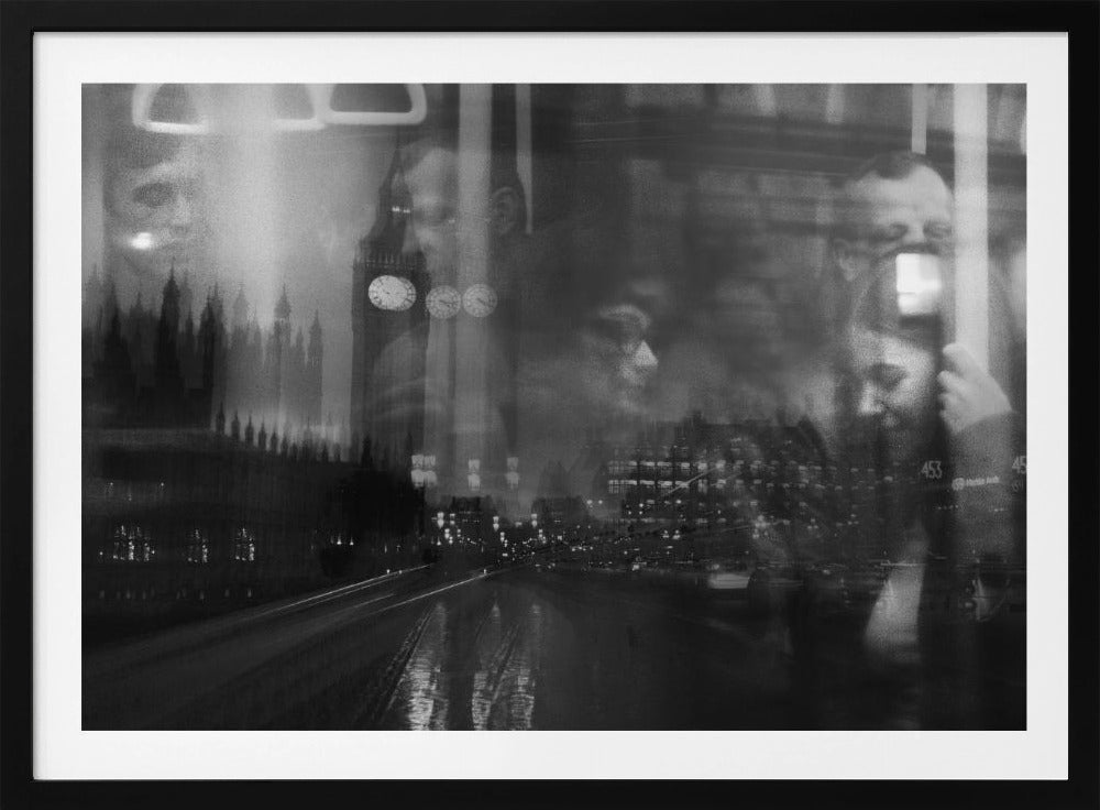 A moody black and white double exposure photograph showing a rainy London street at night with Big Ben, overlaid with the faint reflections of people inside a moving vehicle like a bus. The image has a dreamy, layered effect and is displayed in a silver frame. Print