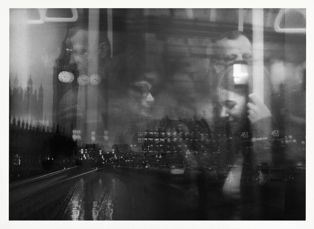 A moody black and white double exposure photograph showing a rainy London street at night with Big Ben, overlaid with the faint reflections of people inside a moving vehicle like a bus. The image has a dreamy, layered effect and is displayed in a silver frame. Print