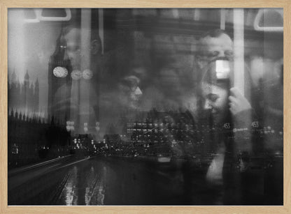 A moody black and white double exposure photograph showing a rainy London street at night with Big Ben, overlaid with the faint reflections of people inside a moving vehicle like a bus. The image has a dreamy, layered effect and is displayed in a silver frame. Print