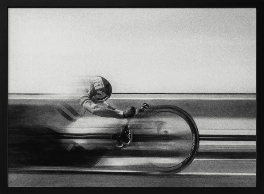 A black and white photograph captured with motion blur, showing a cyclist in an aerodynamic position racing at high speed. The background is blurred into horizontal lines, emphasizing the velocity. The image is enclosed in a silver frame. Wall Art