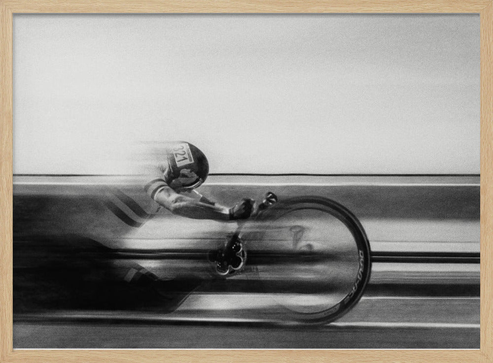 A black and white photograph captured with motion blur, showing a cyclist in an aerodynamic position racing at high speed. The background is blurred into horizontal lines, emphasizing the velocity. The image is enclosed in a silver frame. Wall Art