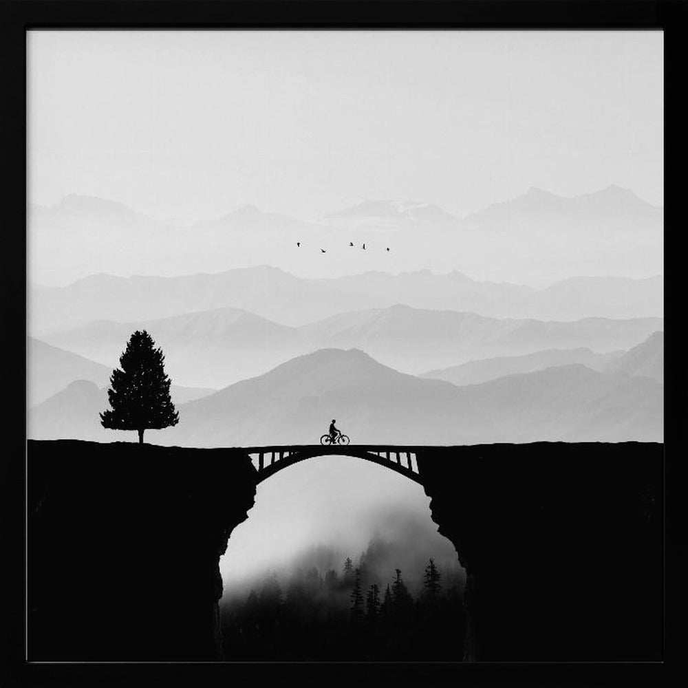 A minimalist black and white artwork featuring the silhouette of a cyclist crossing a high arched bridge between two cliffs. A lone tree stands on one cliff, while layers of misty mountains fill the background, creating a sense of depth and solitude. Poster