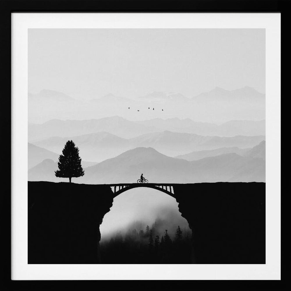 A minimalist black and white artwork featuring the silhouette of a cyclist crossing a high arched bridge between two cliffs. A lone tree stands on one cliff, while layers of misty mountains fill the background, creating a sense of depth and solitude. Poster