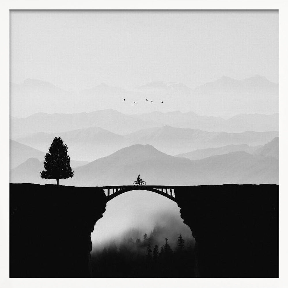 A minimalist black and white artwork featuring the silhouette of a cyclist crossing a high arched bridge between two cliffs. A lone tree stands on one cliff, while layers of misty mountains fill the background, creating a sense of depth and solitude. Poster