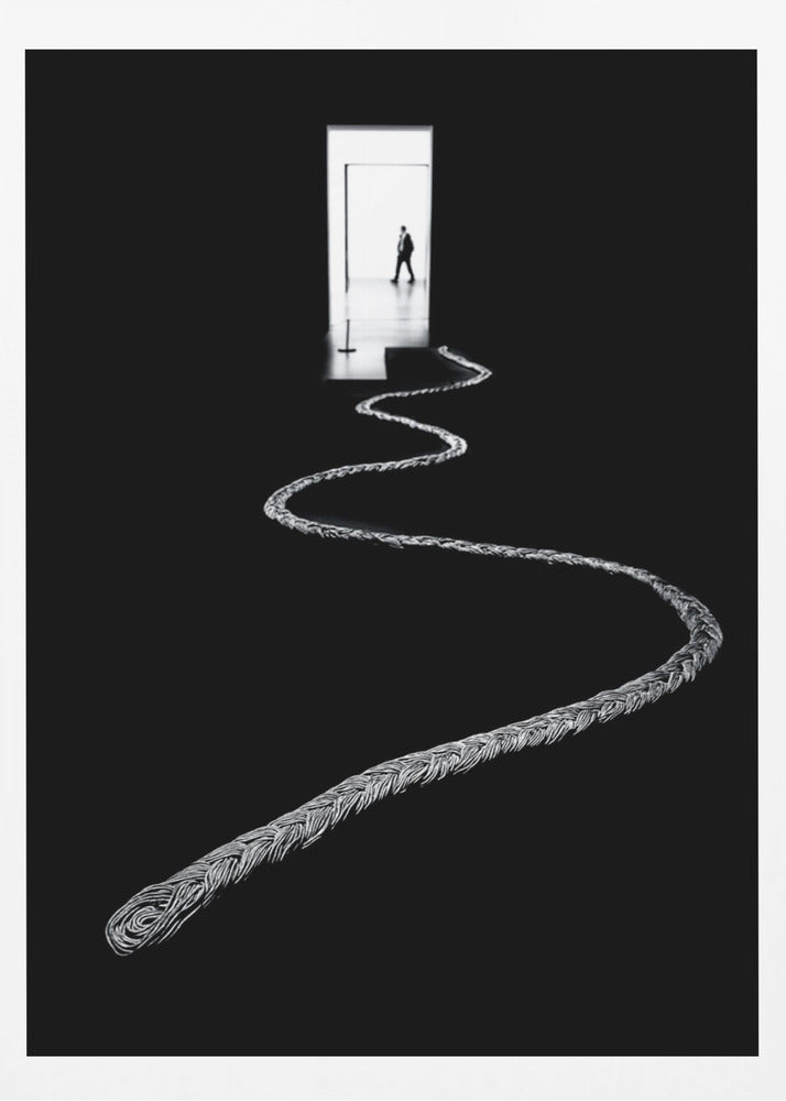 A high-contrast, black and white photograph of a thick, silver, braided rope winding across a black floor, leading towards a brightly lit doorway in the distance where a silhouetted man is walking away. Wall Art