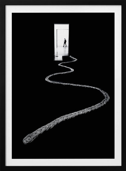 A high-contrast, black and white photograph of a thick, silver, braided rope winding across a black floor, leading towards a brightly lit doorway in the distance where a silhouetted man is walking away. Wall Art