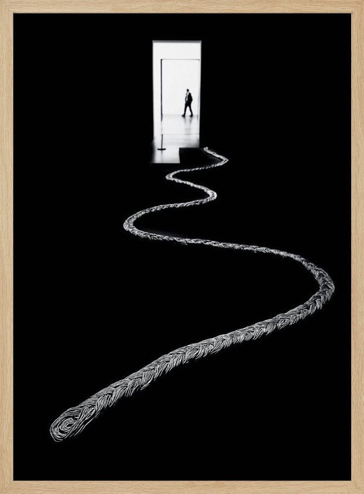 A high-contrast, black and white photograph of a thick, silver, braided rope winding across a black floor, leading towards a brightly lit doorway in the distance where a silhouetted man is walking away. Wall Art