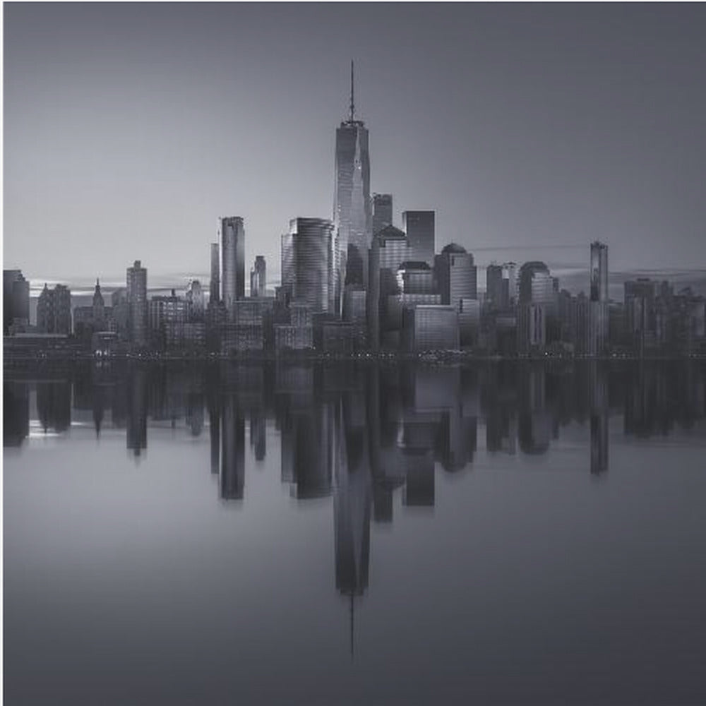 A framed, moody black and white photograph of the Lower Manhattan skyline, featuring the One World Trade Center, with a perfect, still reflection of the skyscrapers in the water below. Decor
