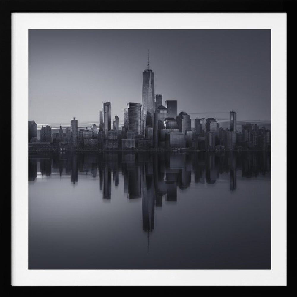 A framed, moody black and white photograph of the Lower Manhattan skyline, featuring the One World Trade Center, with a perfect, still reflection of the skyscrapers in the water below. Decor