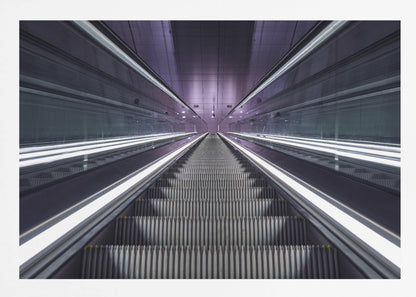 A symmetrical, first-person view looking down a long, empty escalator in a modern subway station, with bright white lights lining the handrails and a purple glow on the ceiling, creating a futuristic and infinite perspective. Wall Art