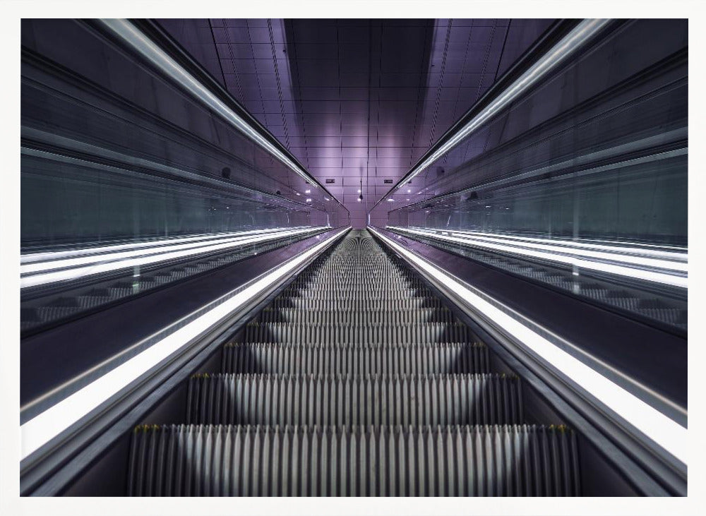 A symmetrical, first-person view looking down a long, empty escalator in a modern subway station, with bright white lights lining the handrails and a purple glow on the ceiling, creating a futuristic and infinite perspective. Wall Art