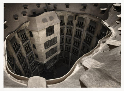 A surreal, high-angle photograph looking down into the distorted, cavernous courtyard of a building. The walls and windows appear to melt and curve inwards towards a dark void, creating a powerful optical illusion. The image has a muted, sepia-toned color palette and is presented in a silver frame. Wall Art