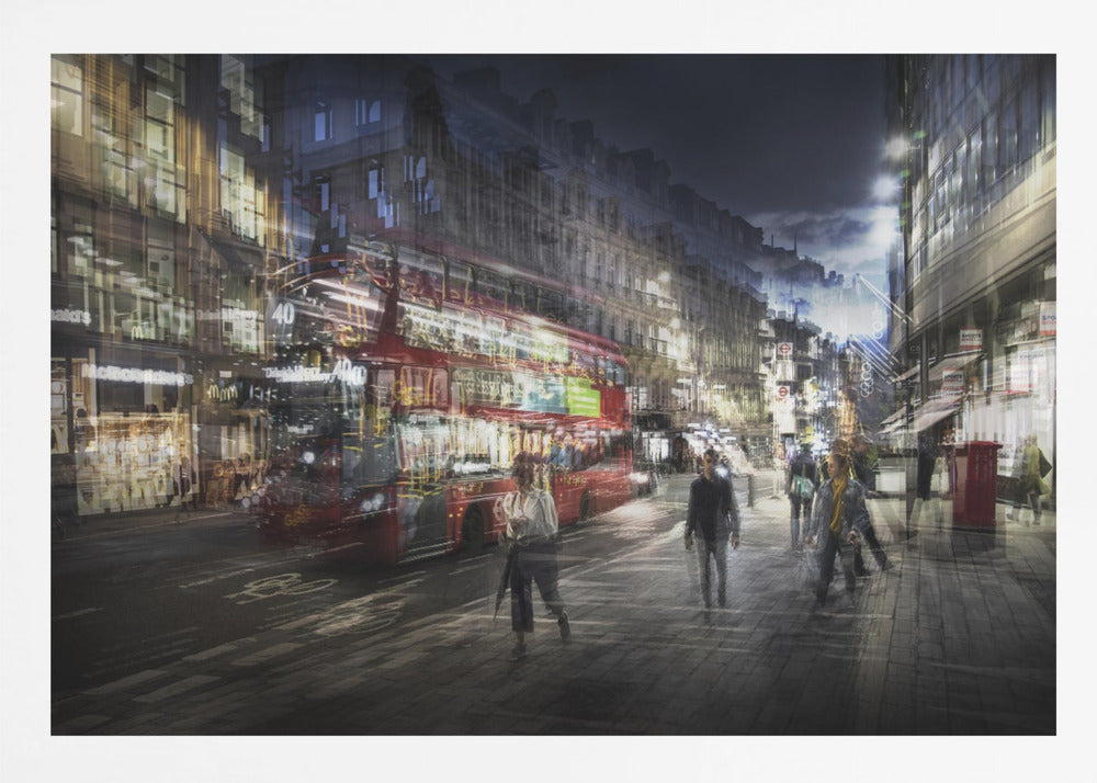 A long-exposure, artistic photograph of a busy London street at night. The motion of a red double-decker bus and pedestrians creates a blurred, ghost-like effect, capturing the vibrant energy of the city. The scene is illuminated by streetlights and building windows, all set within a silver frame. Artwork