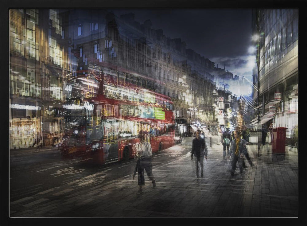 A long-exposure, artistic photograph of a busy London street at night. The motion of a red double-decker bus and pedestrians creates a blurred, ghost-like effect, capturing the vibrant energy of the city. The scene is illuminated by streetlights and building windows, all set within a silver frame. Artwork