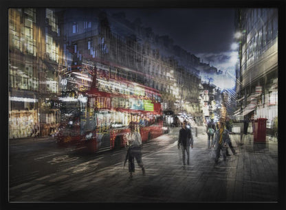A long-exposure, artistic photograph of a busy London street at night. The motion of a red double-decker bus and pedestrians creates a blurred, ghost-like effect, capturing the vibrant energy of the city. The scene is illuminated by streetlights and building windows, all set within a silver frame. Artwork