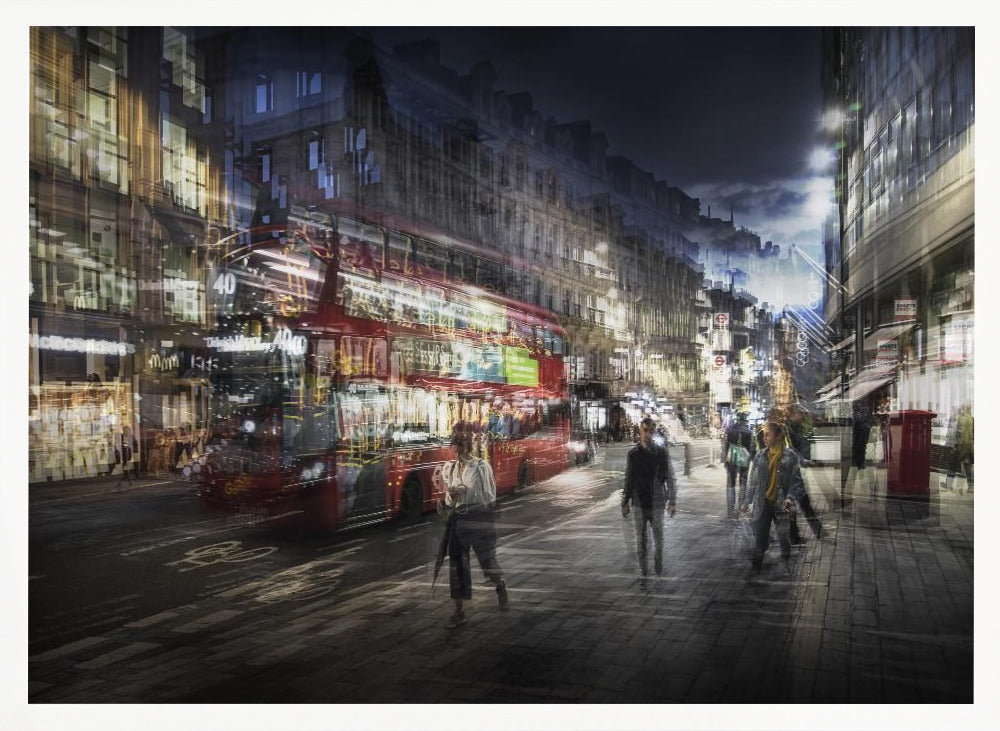 A long-exposure, artistic photograph of a busy London street at night. The motion of a red double-decker bus and pedestrians creates a blurred, ghost-like effect, capturing the vibrant energy of the city. The scene is illuminated by streetlights and building windows, all set within a silver frame. Artwork