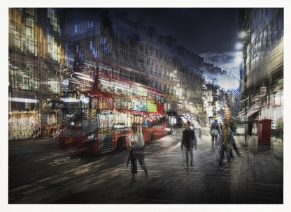 A long-exposure, artistic photograph of a busy London street at night. The motion of a red double-decker bus and pedestrians creates a blurred, ghost-like effect, capturing the vibrant energy of the city. The scene is illuminated by streetlights and building windows, all set within a silver frame. Artwork