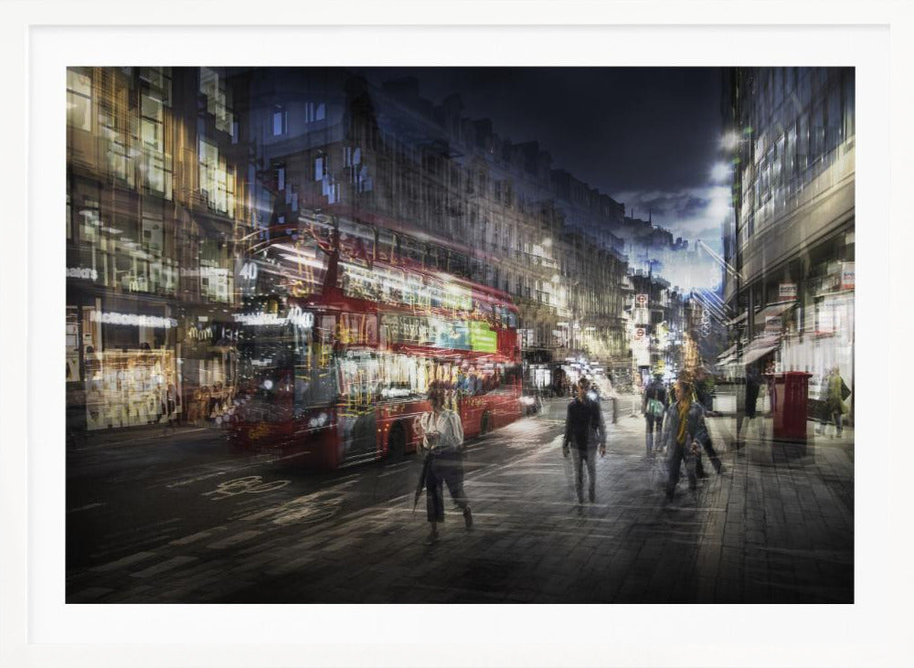 A long-exposure, artistic photograph of a busy London street at night. The motion of a red double-decker bus and pedestrians creates a blurred, ghost-like effect, capturing the vibrant energy of the city. The scene is illuminated by streetlights and building windows, all set within a silver frame. Artwork