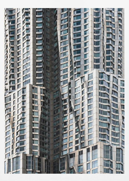 A close-up photograph of the facade of a modern skyscraper with an undulating, wave-like metallic exterior. The building is filled with windows that reflect the light, creating a dynamic pattern of highlights and shadows, all captured within a black frame. Print
