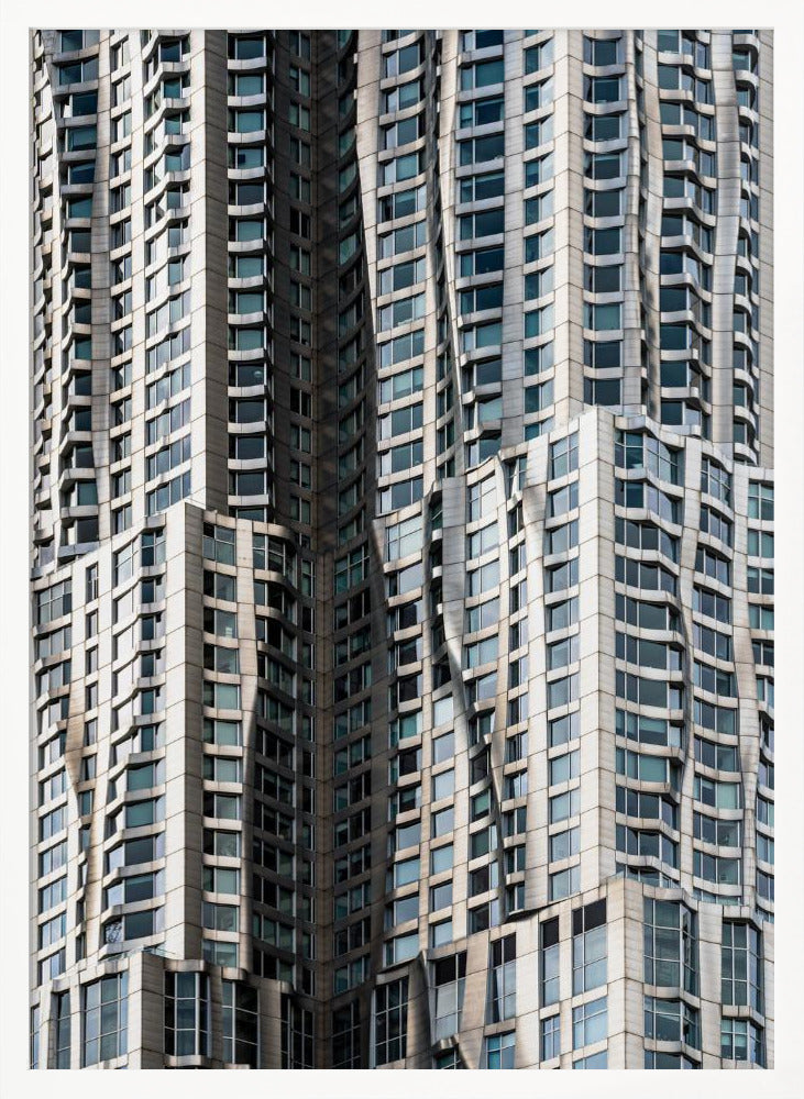 A close-up photograph of the facade of a modern skyscraper with an undulating, wave-like metallic exterior. The building is filled with windows that reflect the light, creating a dynamic pattern of highlights and shadows, all captured within a black frame. Print
