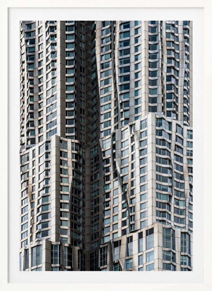 A close-up photograph of the facade of a modern skyscraper with an undulating, wave-like metallic exterior. The building is filled with windows that reflect the light, creating a dynamic pattern of highlights and shadows, all captured within a black frame. Print