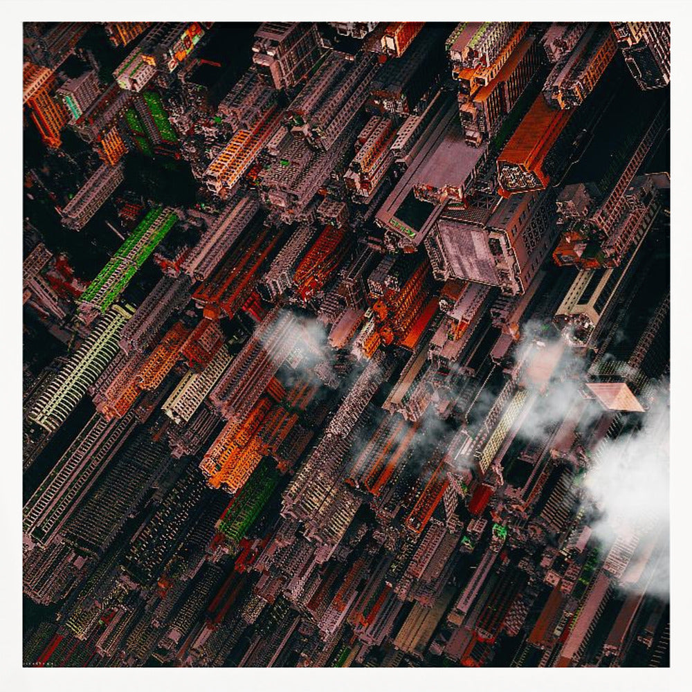 A dramatic, high-angle aerial photograph looking straight down into a super-dense, futuristic cityscape with towering skyscrapers packed together, featuring pops of orange and green among the dark buildings. Wisps of clouds float between the towers, and the image is presented in a light wood frame. Print